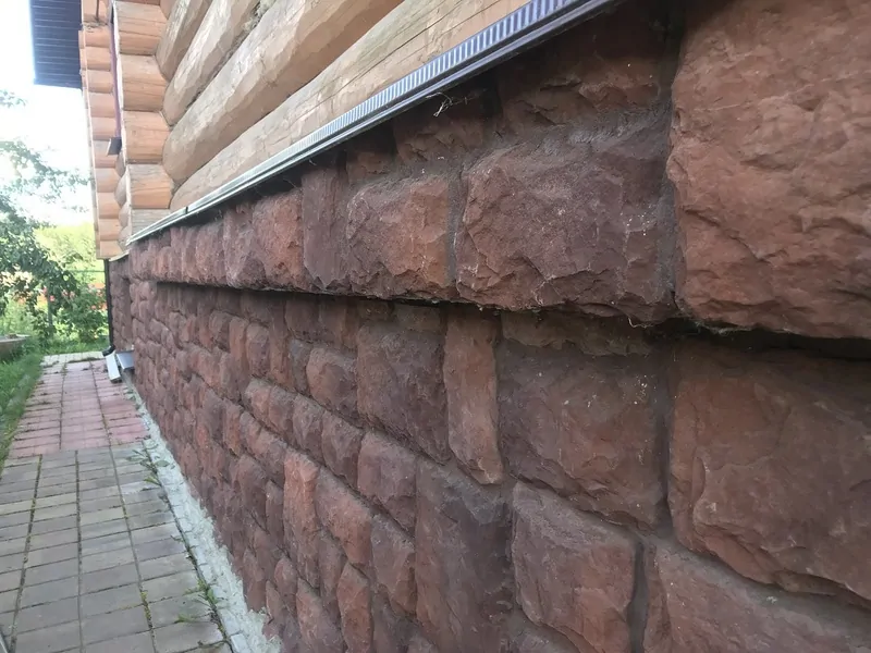 Фото: в домах, построенных на участке с уклоном, цоколь может переходить в подвал – со стороны уклона высота пространства под домом больше, © oknamedia 